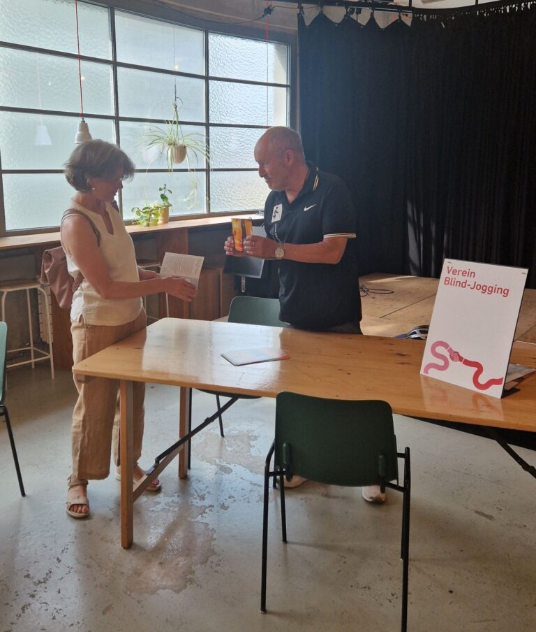 Freiwilligenmesse in Basel 2026: Präsident Gabor am Blind-Jogging Stand im Austausch mit einer interessierten Dame